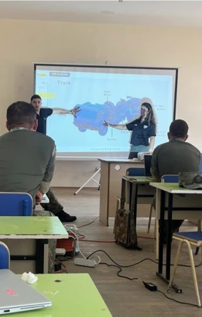 Instructors presenting a modelled assembly to trainees in a classroom