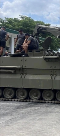 A training group working with a tracked vehicle outdoors